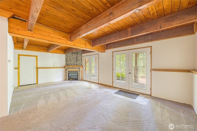 71 Waggler Way, Sequim, WA 98382 - unfurnished living room with french doors, a wooden ceiling with exposed beams, carpet floors, and a large fireplace