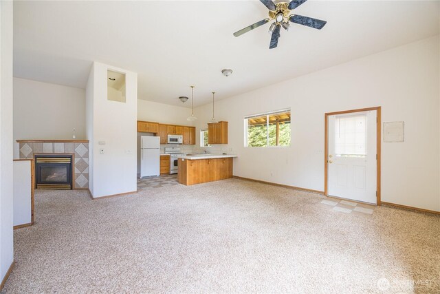 71 Waggler Way, Sequim, WA 98382 - unfurnished living room with light carpet, a tiled fireplace, and ceiling fan