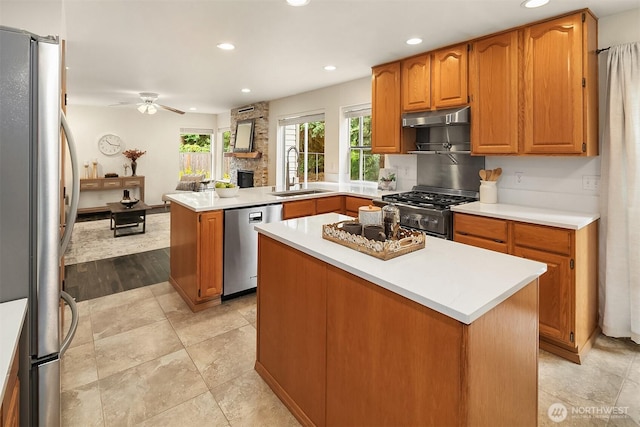 12820 SE 243rd St, Kent, WA 98030 - kitchen featuring appliances with stainless steel finishes, under cabinet range hood, recessed lighting, ceiling fan, and a peninsula