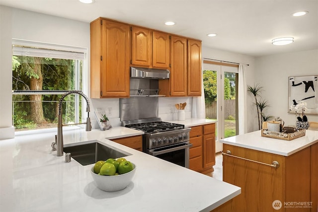 12820 SE 243rd St, Kent, WA 98030 - kitchen featuring stainless steel range with gas stovetop, light countertops, recessed lighting, under cabinet range hood, and brown cabinetry