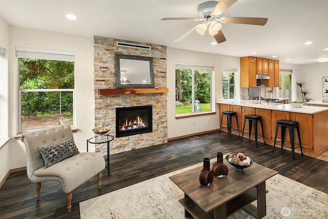 12820 SE 243rd St, Kent, WA 98030 - living area with healthy amount of natural light, dark wood-style flooring, ceiling fan, a stone fireplace, and recessed lighting