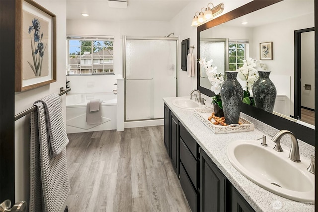 12820 SE 243rd St, Kent, WA 98030 - full bathroom featuring a stall shower, wood finished floors, a bath, and double vanity
