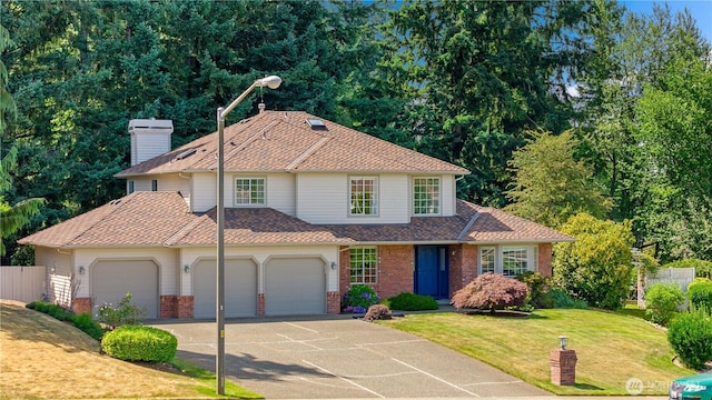 12820 SE 243rd St, Kent, WA 98030 - traditional home featuring brick siding, driveway, a shingled roof, and an attached garage