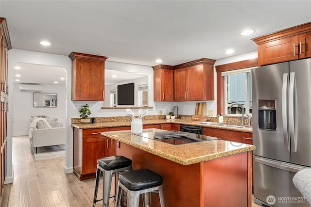 1339 N 167th St, Shoreline, WA 98133 - kitchen featuring stainless steel refrigerator with ice dispenser, a center island, a wall unit AC, stovetop with downdraft, and light wood-style floors
