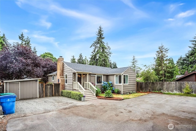 1339 N 167th St, Shoreline, WA 98133 - ranch-style home featuring a storage unit, a chimney, and roof with shingles
