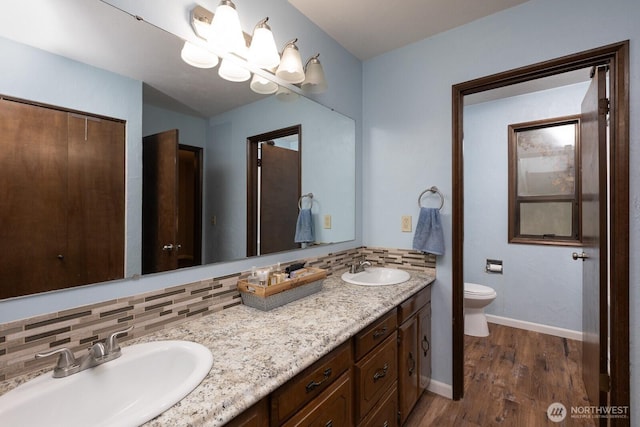 1927 SE Maple Dr, Chehalis, WA 98532 - bathroom featuring double vanity, wood finished floors, and tasteful backsplash