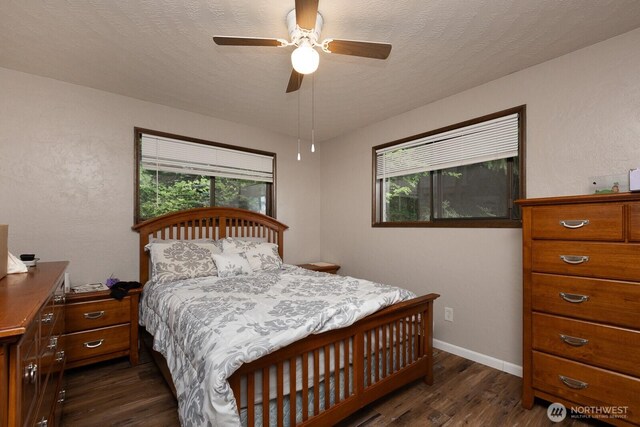 1927 SE Maple Dr, Chehalis, WA 98532 - bedroom with dark wood-style floors, multiple windows, and a ceiling fan