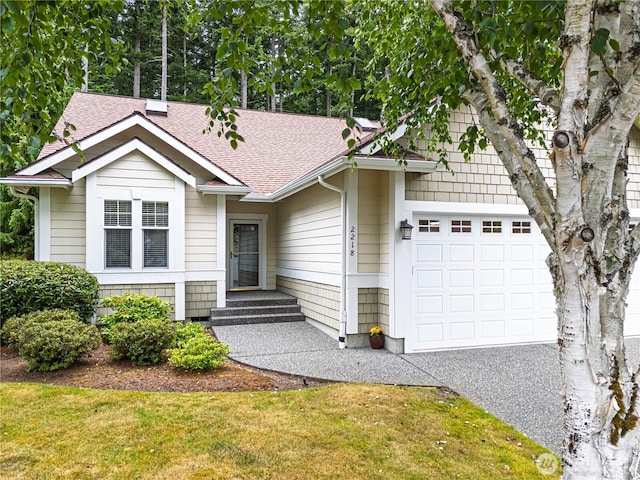2218 Cascade Ct, Anacortes, WA 98221 - view of front facade with a shingled roof, a garage, and a front lawn