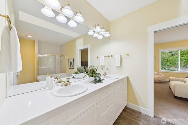 2218 Cascade Ct, Anacortes, WA 98221 - full bath featuring double vanity, a shower with door, connected bathroom, and wood finished floors