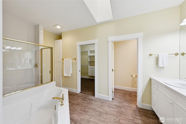 2218 Cascade Ct, Anacortes, WA 98221 - full bathroom featuring a stall shower, a bath, wood finished floors, vanity, and a skylight