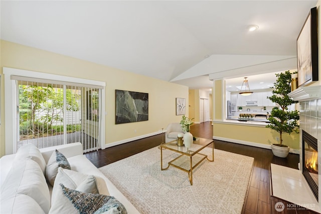 2218 Cascade Ct, Anacortes, WA 98221 - living area with vaulted ceiling, dark wood-type flooring, and a tile fireplace