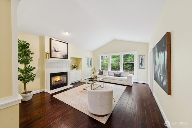 2218 Cascade Ct, Anacortes, WA 98221 - living room featuring a tiled fireplace, dark wood-style floors, and lofted ceiling