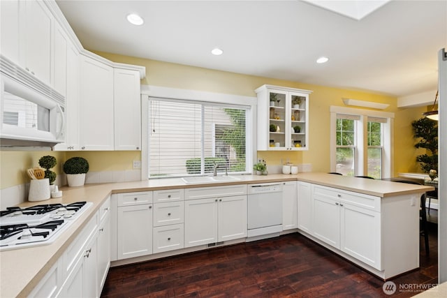 2218 Cascade Ct, Anacortes, WA 98221 - kitchen with white appliances, a peninsula, dark wood-style floors, light countertops, and recessed lighting