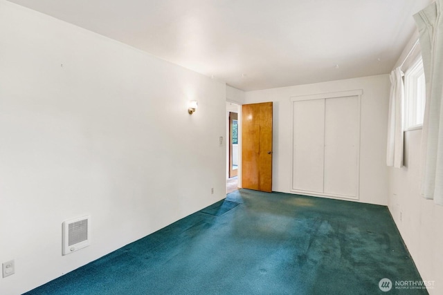4210 Lakeway Dr, Bellingham, WA 98229 - unfurnished bedroom featuring carpet, multiple windows, and a closet