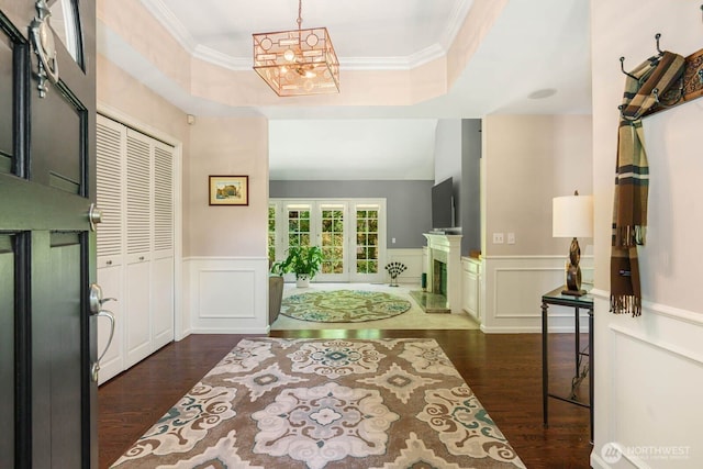 2444 220th Pl NE, Sammamish, WA 98074 - bathroom with wood finished floors, a chandelier, a wainscoted wall, a raised ceiling, and a decorative wall