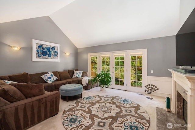 2444 220th Pl NE, Sammamish, WA 98074 - living area with light colored carpet, a wainscoted wall, a fireplace, high vaulted ceiling, and a decorative wall