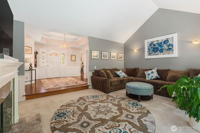 2444 220th Pl NE, Sammamish, WA 98074 - living room featuring carpet floors, a fireplace, vaulted ceiling, and a chandelier