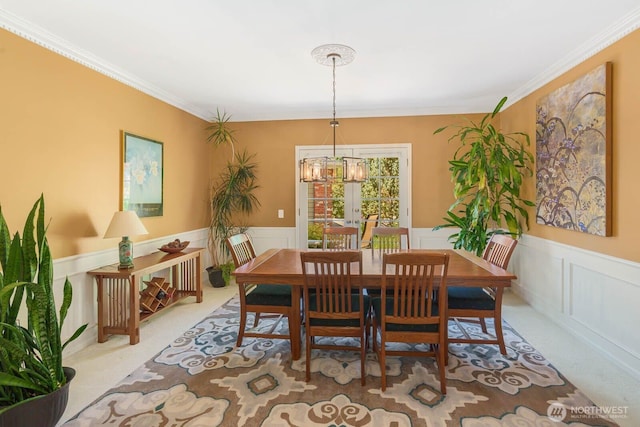 2444 220th Pl NE, Sammamish, WA 98074 - carpeted dining space featuring a chandelier, wainscoting, a decorative wall, and crown molding