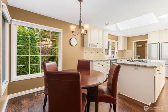 2444 220th Pl NE, Sammamish, WA 98074 - dining space featuring a skylight, dark wood-style floors, and a chandelier