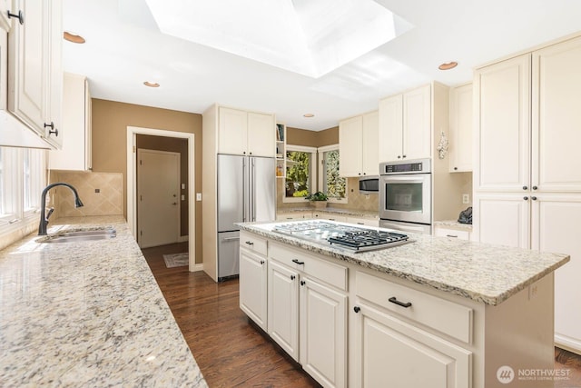 2444 220th Pl NE, Sammamish, WA 98074 - kitchen with appliances with stainless steel finishes, tasteful backsplash, light stone countertops, a kitchen island, and recessed lighting