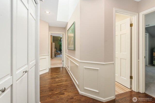 2444 220th Pl NE, Sammamish, WA 98074 - hallway with wood finished floors, wainscoting, a decorative wall, and recessed lighting
