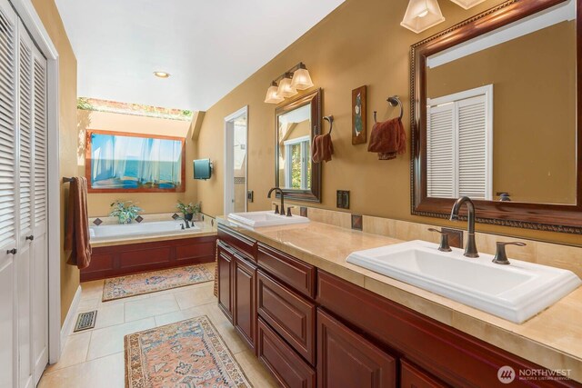2444 220th Pl NE, Sammamish, WA 98074 - bathroom featuring a closet, double vanity, a garden tub, tile patterned flooring, and recessed lighting