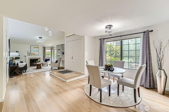 16142 SE 33rd Ln, Unit Bellevue, WA 98008 - dining area with light wood-style floors and a fireplace