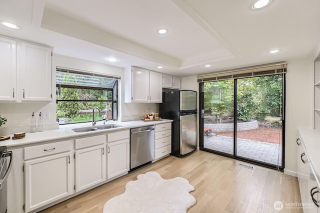 16142 SE 33rd Ln, Unit Bellevue, WA 98008 - kitchen featuring stainless steel appliances, healthy amount of natural light, recessed lighting, white cabinetry, and light countertops