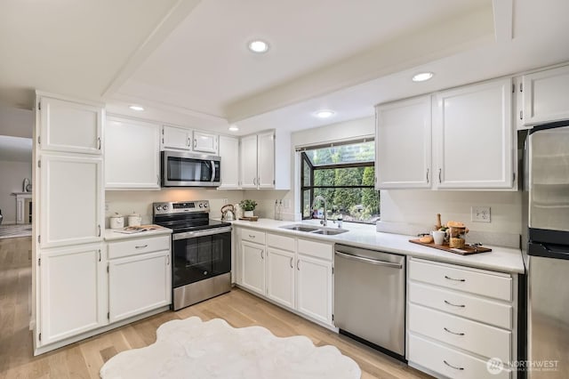 16142 SE 33rd Ln, Unit Bellevue, WA 98008 - kitchen with stainless steel appliances, recessed lighting, white cabinetry, light countertops, and light wood-style floors