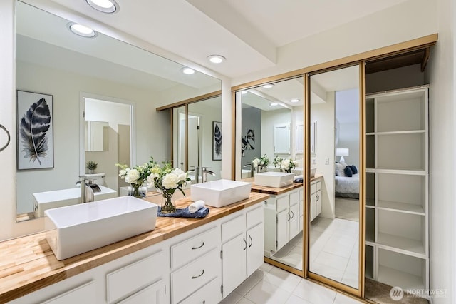 16142 SE 33rd Ln, Unit Bellevue, WA 98008 - full bath featuring double vanity, recessed lighting, tile patterned floors, and ensuite bath