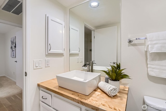 16142 SE 33rd Ln, Unit Bellevue, WA 98008 - bathroom featuring vanity, wood finished floors, and recessed lighting