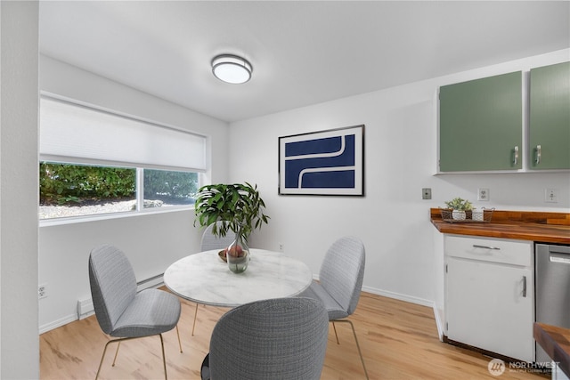 7021 Sand Point Way NE Unit B201, Seattle, WA 98115 - dining room with light wood finished floors and a baseboard radiator