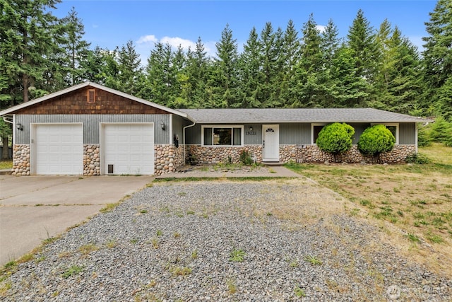 19221 Patterson Rd E, Orting, WA 98360 - single story home with stone siding, a garage, driveway, and a shingled roof
