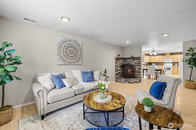 19221 Patterson Rd E, Orting, WA 98360 - living area featuring light wood-style floors, a chandelier, recessed lighting, and a fireplace