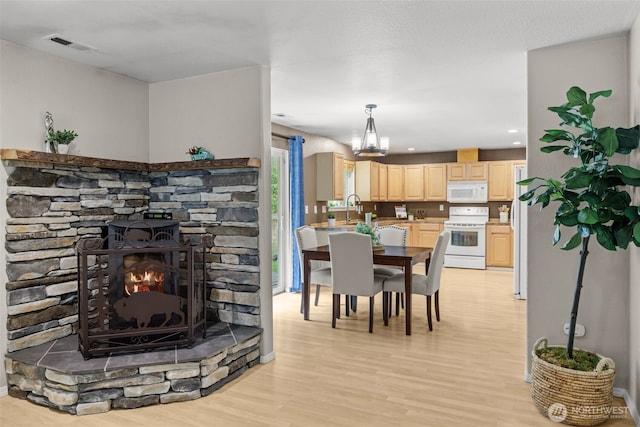19221 Patterson Rd E, Orting, WA 98360 - dining room featuring light wood finished floors, a chandelier, and recessed lighting
