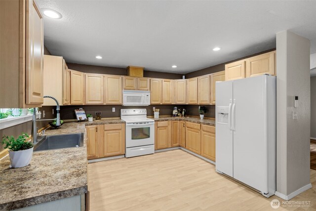 19221 Patterson Rd E, Orting, WA 98360 - kitchen with white appliances, light brown cabinetry, light wood-style floors, and recessed lighting
