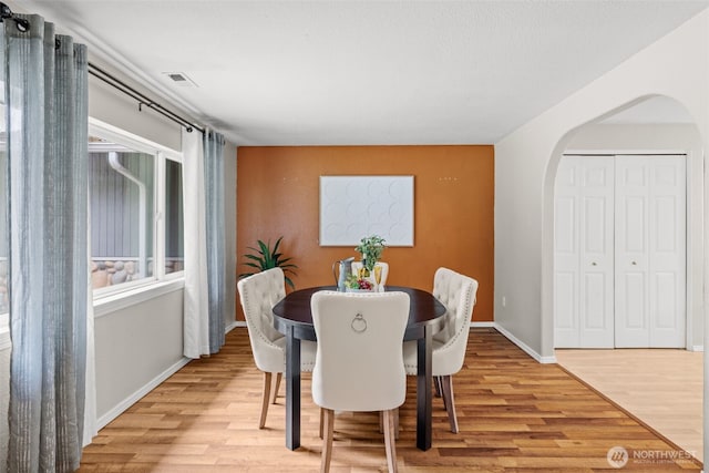 19221 Patterson Rd E, Orting, WA 98360 - dining space with arched walkways and light wood-style floors