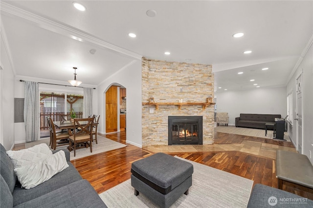 4248 A St SE Unit 423, Auburn, WA 98002 - living room with arched walkways, wood finished floors, ornamental molding, recessed lighting, and a stone fireplace