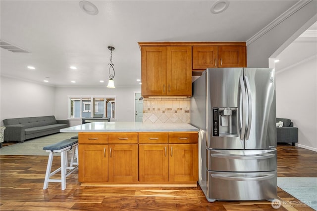 4248 A St SE Unit 423, Auburn, WA 98002 - kitchen featuring stainless steel fridge with ice dispenser, open floor plan, crown molding, decorative backsplash, and wood finished floors