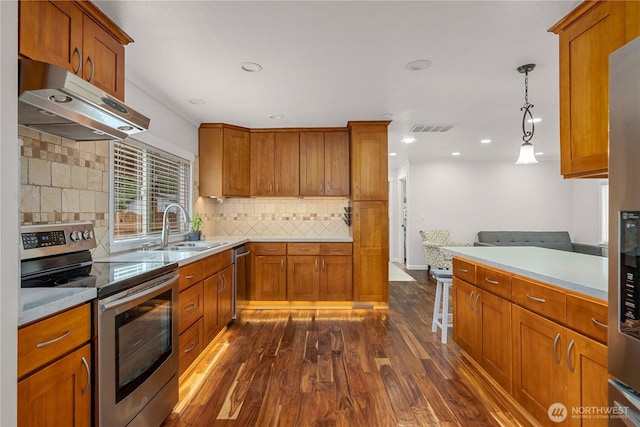 4248 A St SE Unit 423, Auburn, WA 98002 - kitchen featuring stainless steel appliances, ventilation hood, dark wood-style floors, brown cabinets, and backsplash