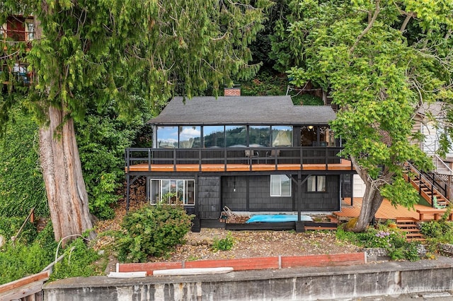 11212 SW 125th St, Vashon, WA 98070 - rear view of property featuring a deck, a chimney, a sunroom, and stairs