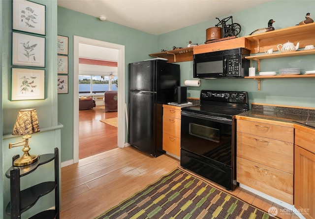 11212 SW 125th St, Vashon, WA 98070 - kitchen featuring black appliances, light wood finished floors, open shelves, and tile countertops