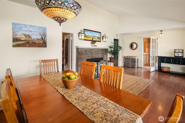 11212 SW 125th St, Vashon, WA 98070 - dining room with wood finished floors, a tile fireplace, high vaulted ceiling, and a baseboard heating unit