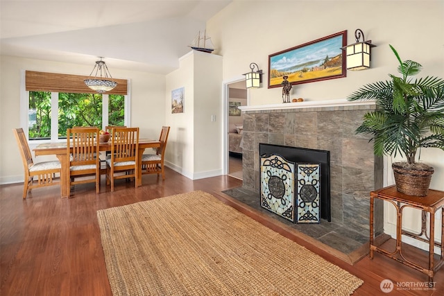 11212 SW 125th St, Vashon, WA 98070 - dining room featuring vaulted ceiling, a tiled fireplace, and wood finished floors