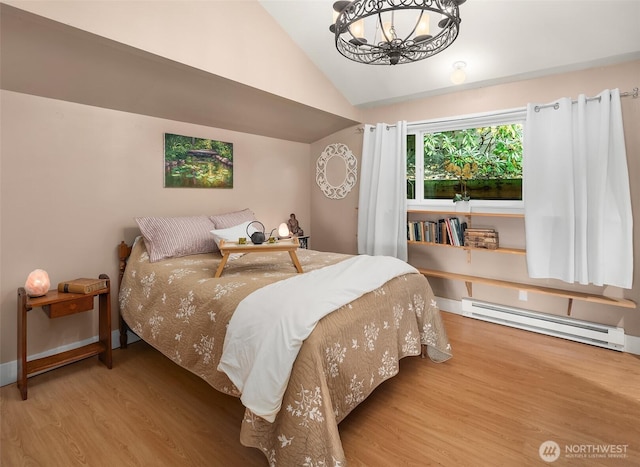 11212 SW 125th St, Vashon, WA 98070 - bedroom with a baseboard radiator, wood finished floors, vaulted ceiling, and a chandelier