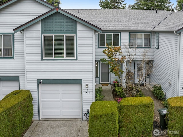 23501 112th Ave SE Unit F103, Kent, WA 98031 - view of property with an attached garage and a shingled roof