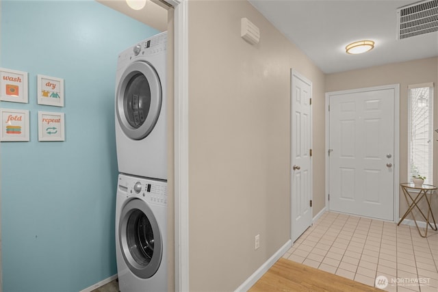 23501 112th Ave SE Unit F103, Kent, WA 98031 - laundry room with stacked washer and clothes dryer and light tile patterned floors
