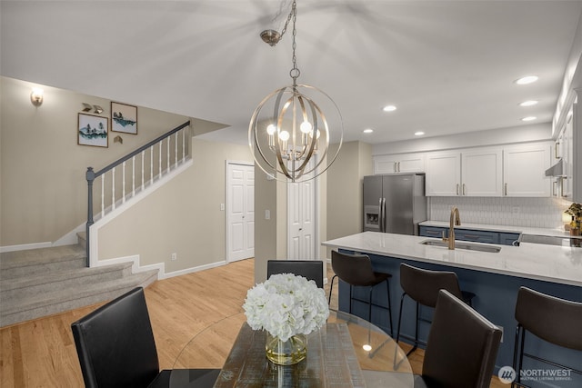 23501 112th Ave SE Unit F103, Kent, WA 98031 - dining space with a chandelier, stairs, light wood-type flooring, and recessed lighting