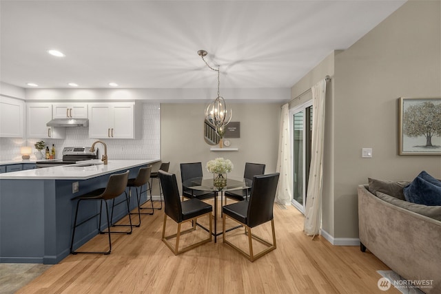 23501 112th Ave SE Unit F103, Kent, WA 98031 - dining space featuring light wood-style floors, a chandelier, and recessed lighting