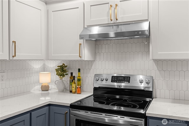 23501 112th Ave SE Unit F103, Kent, WA 98031 - kitchen featuring stainless steel electric stove, under cabinet range hood, tasteful backsplash, and white cabinets